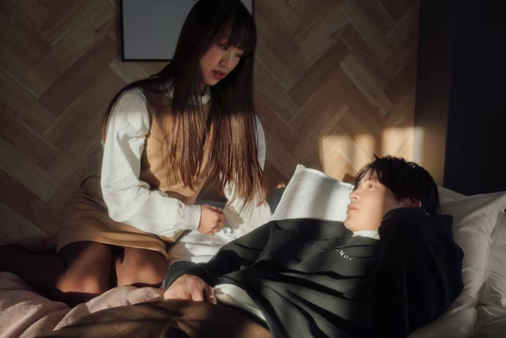 Concerned woman talks to her partner lying in bed, highlighting emotional support during Sleep Disorders Treatment in Nashville.