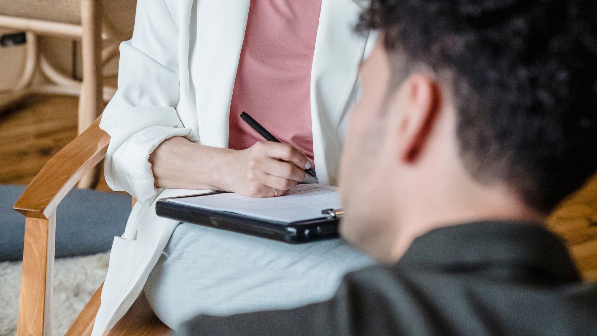 Man going through a list during an interview to assess his condition at a Mental Health Treatment in Hendersonville